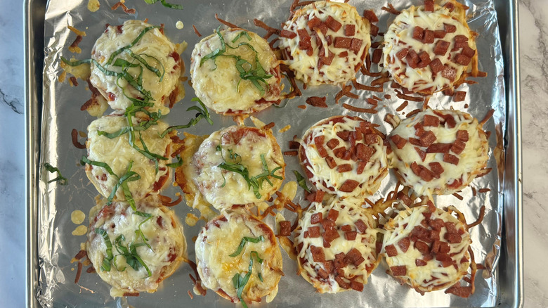 baked pizza bagel bites on lined baking tray