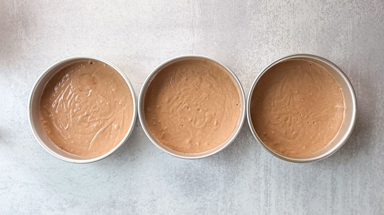 German chocolate cake batter in 3 round cake pans