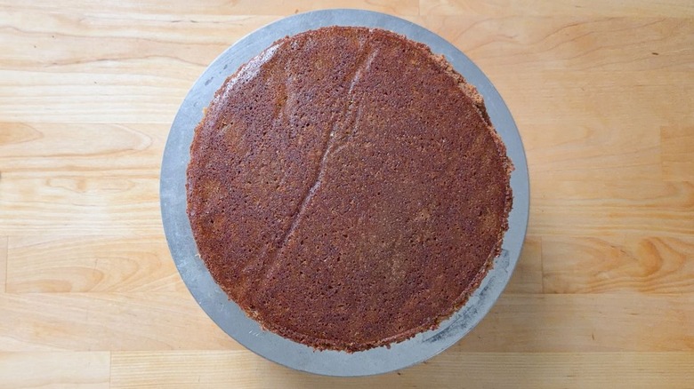 German chocolate cake being assembled on cake stand