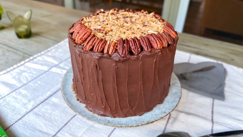 Finished German chocolate cake with pecan halves as garnish