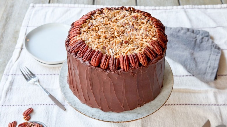 Traditional German chocolate cake on cake stand on table