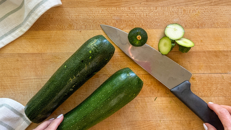 Zucchini and knife on cutting board