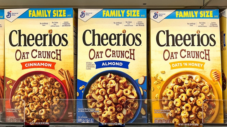 Three boxes of Cheerios Oat Crunch cereal varieties on grocery shelf