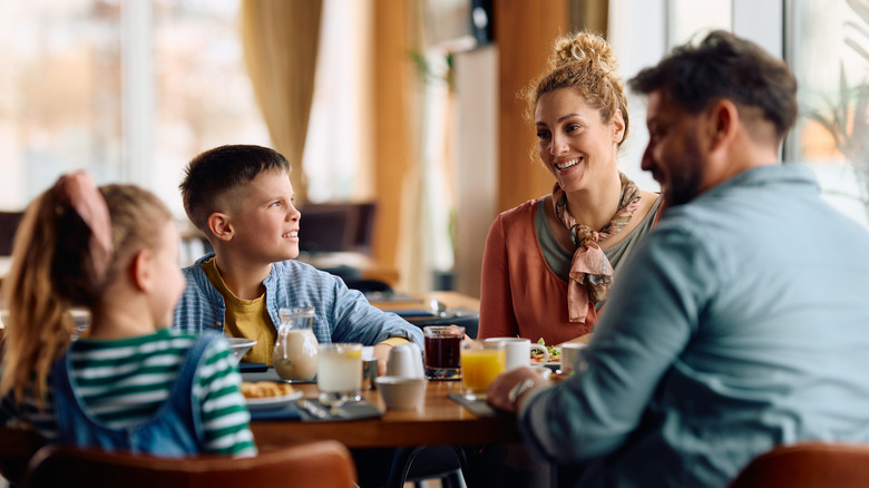 family with two children eats a restaurant meal