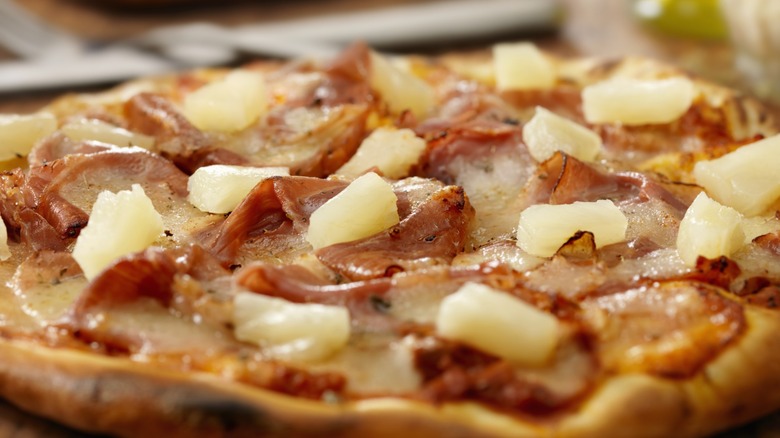pizza with crispy ham and pineapple tidbits