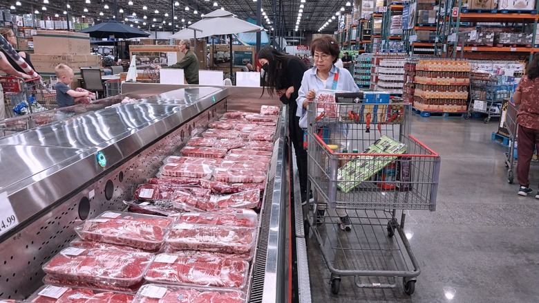shoppers browse the costco meat department