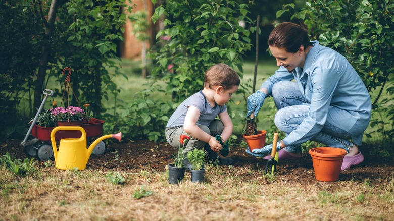 mother and child plant herbs in garden