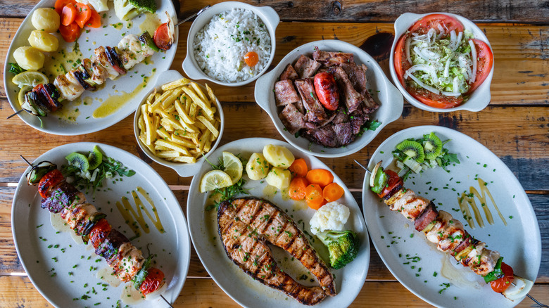 Multiple Portuguese dishes on a wooden table