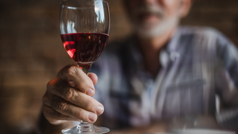 man holding wine glass