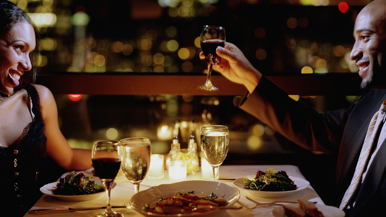 Couple dining at candle-lit restaurant