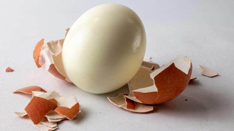 A peeled hard boiled eggs with eggshells