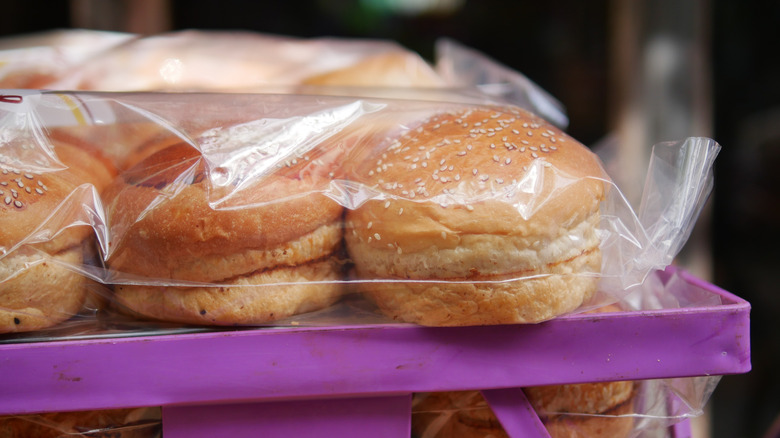 Packages of burger buns at a grocery store shelf