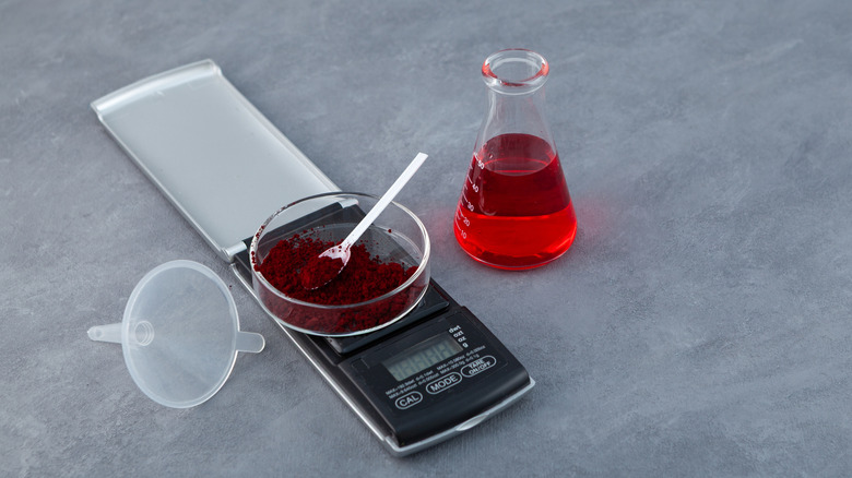 Red food dye on a scale and in a beaker