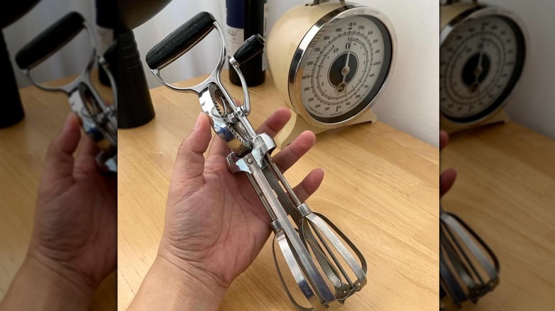 Someone holding a 1950s hand crank whisk