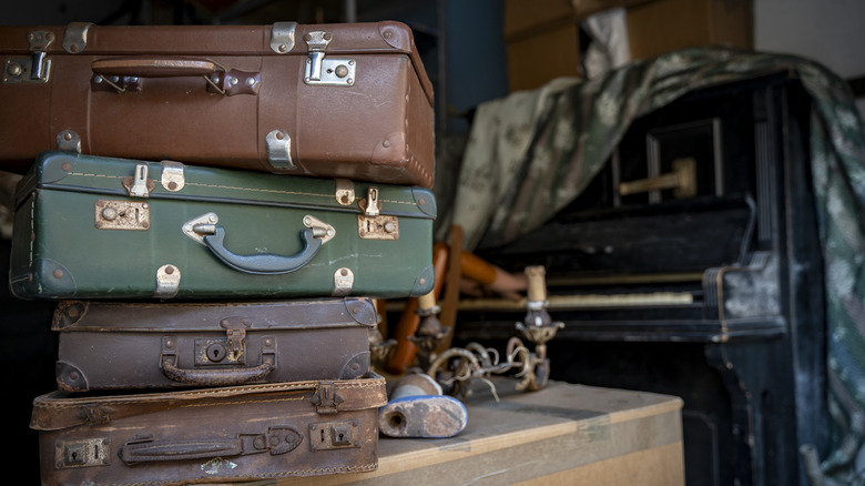 Stacked retro suitcases in an attic closeup