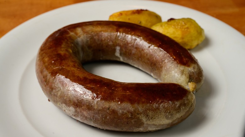 liver sausage on white plate with potato patties