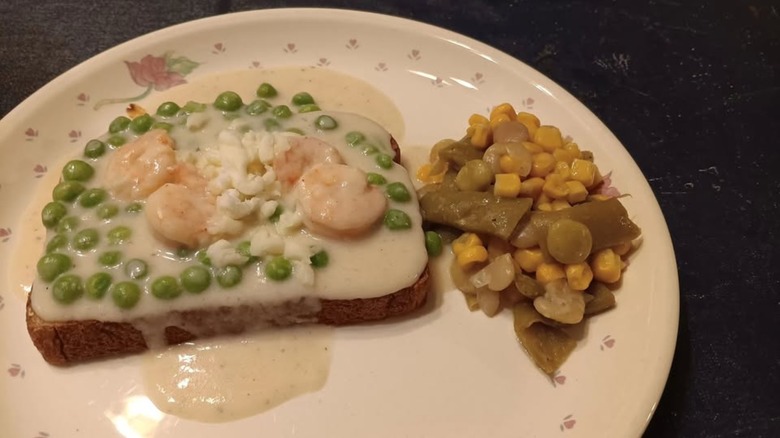 Closeup of white plate with shrimp wiggle ingredients