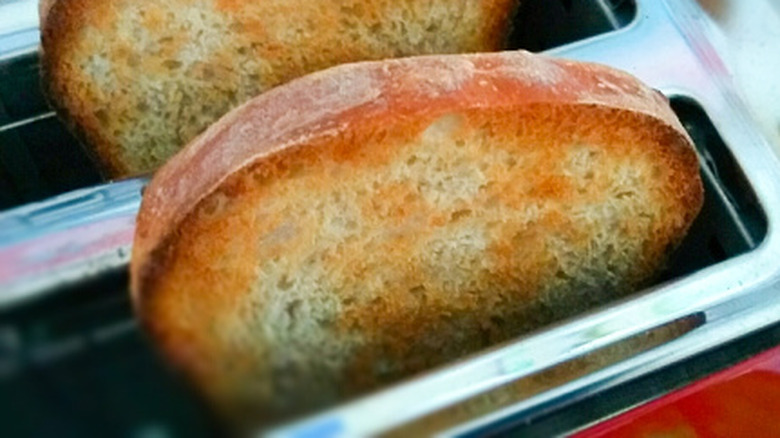 Slices of toast in toaster, closeup