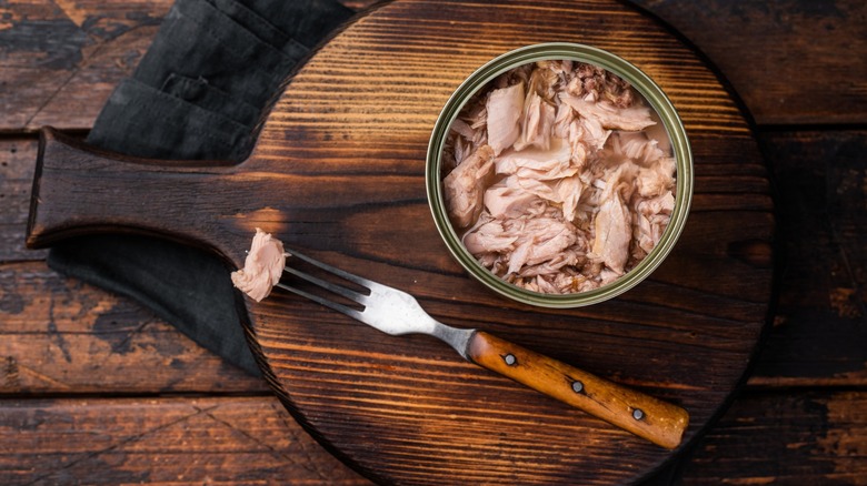 canned tuna with fork on board
