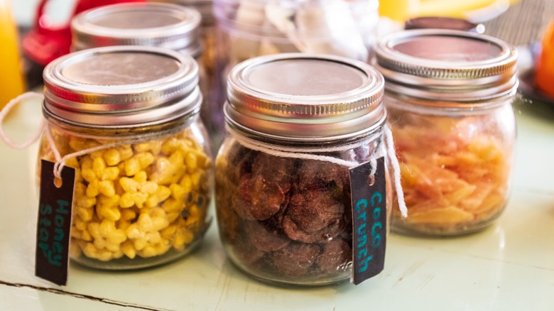 Closeup of snacks in small glass jars.