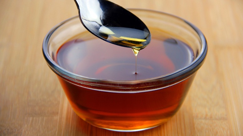 maple syrup drips off spoon