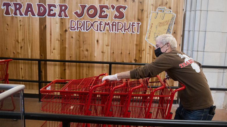 Trader Joe's employee organizing carts