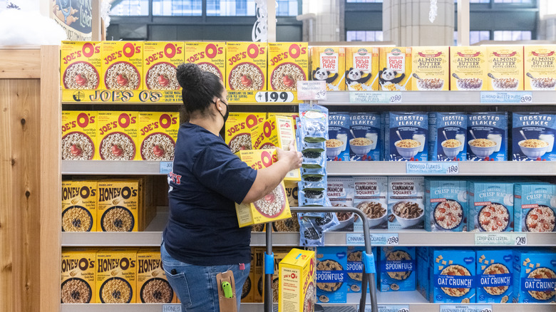 Trader Joe's worker stocking shelves