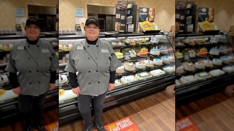bakery manager stands in front of cake display