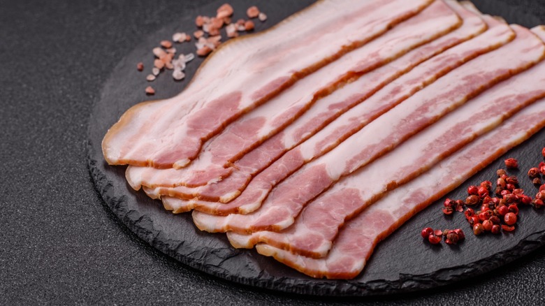 raw bacon resting on a platter