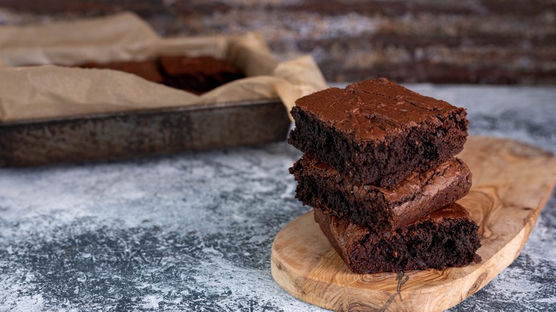 rich chocolate brownies on wooden slab