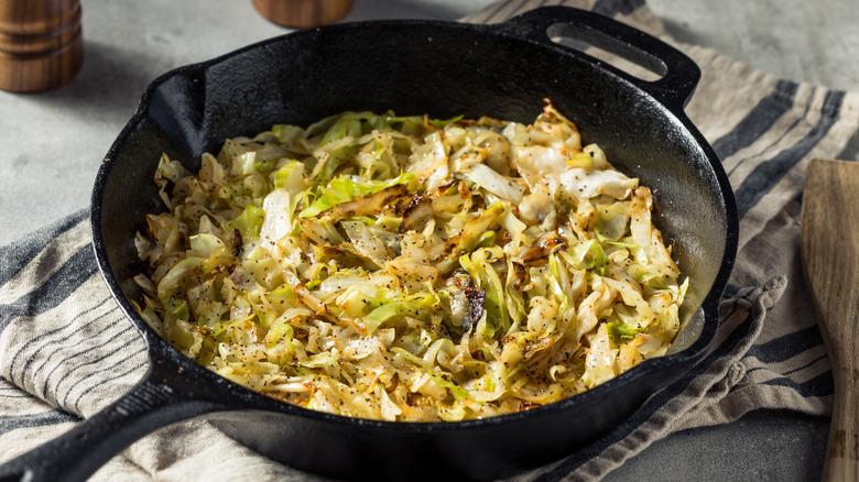 Cast iron pan full of sauteed cabbage