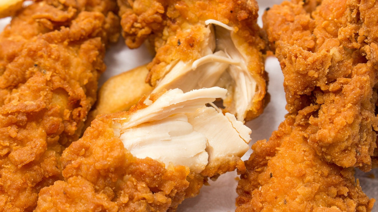 Fried chicken, split open to reveal the juicy meat