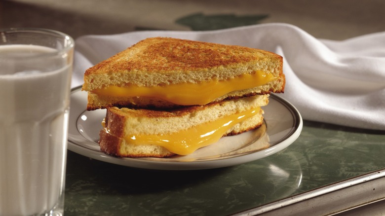 grilled cheese on plate with milk