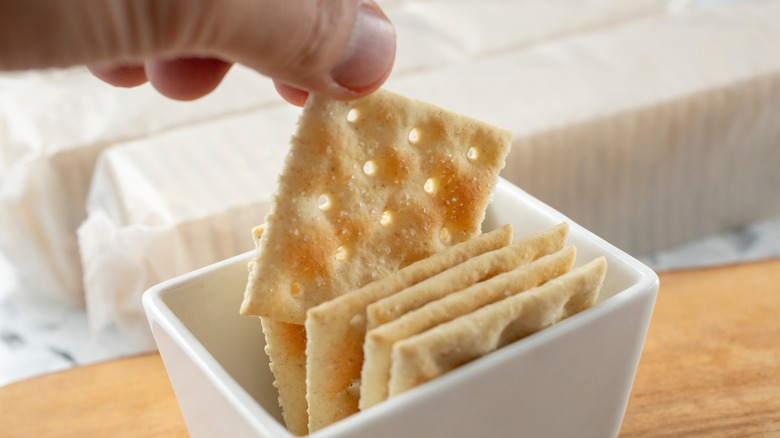 lifting saltines from small cracker cup