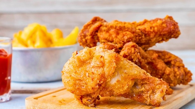 crispy fried chicken on wooden board