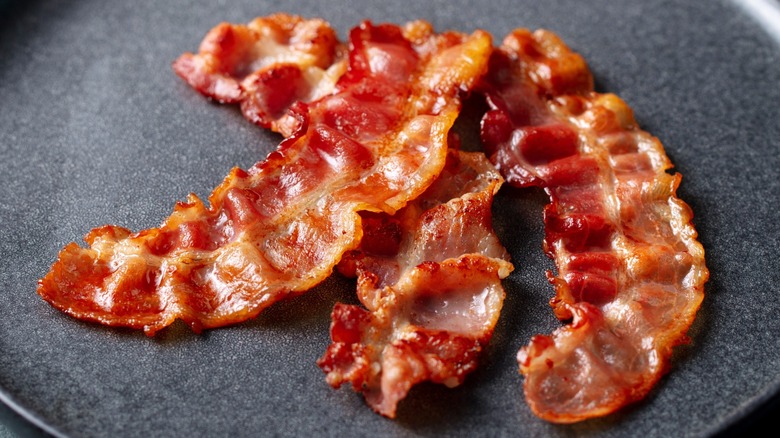 crisp bacon on black plate