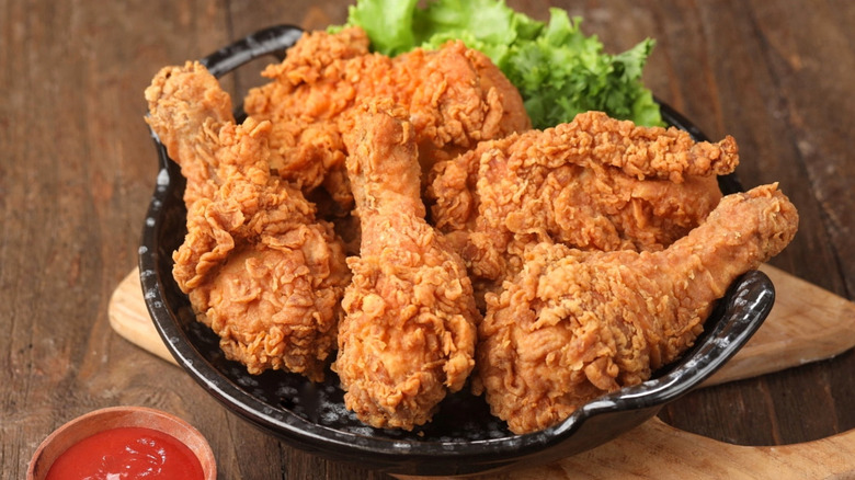 Crispy fried chicken on a black plate
