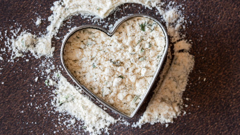 A heart-shaped cutter sitting in a pile of ranch seasoning