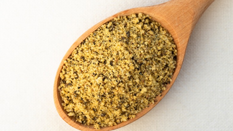 lemon-pepper seasoning on wooden spoon