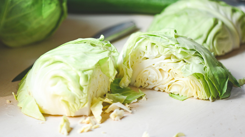 Pieces of a white cabbage on a chopping block