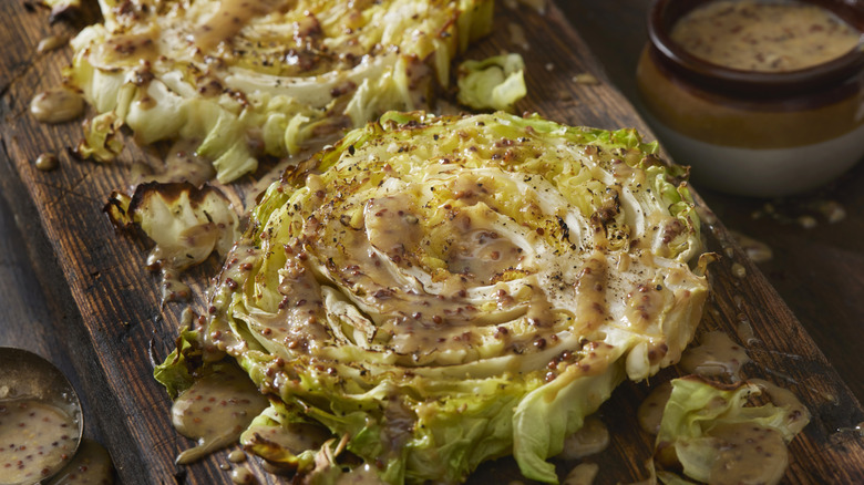 Roasted cabbage steaks on a wooden board