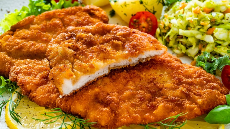 chicken cutlets on plate with sides
