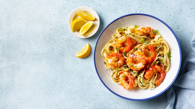 cooked shrimp atop a plate of pasta