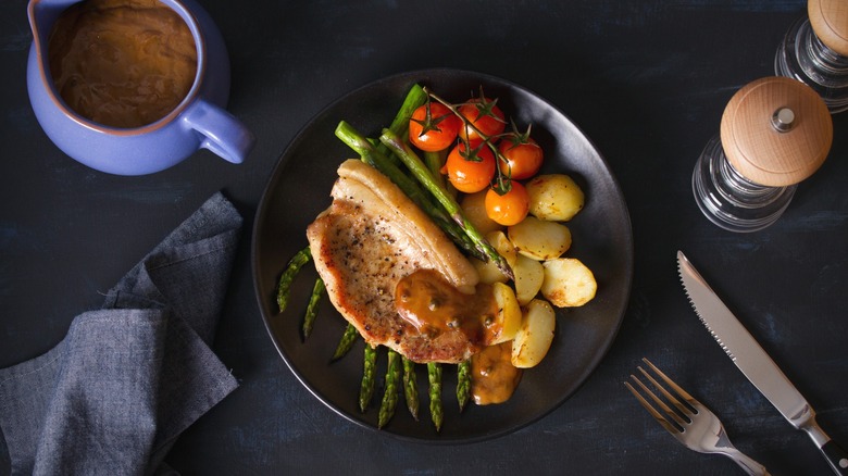 pork chop dinner on plate with veggies