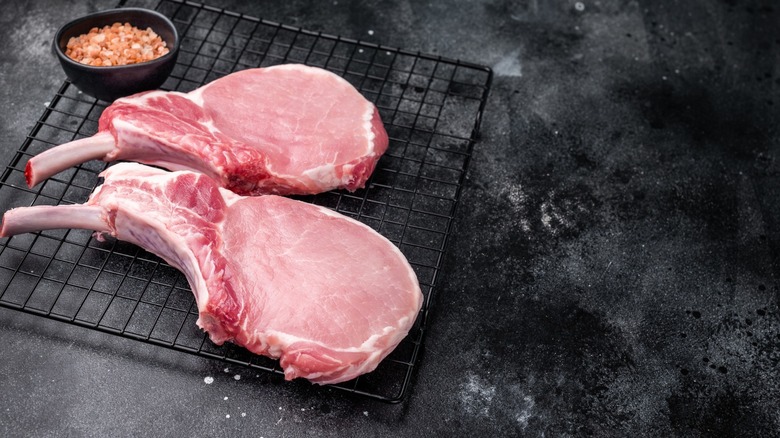 bone-in pork chops on cooking rack