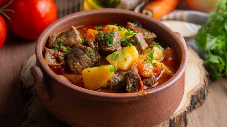 individual helping of beef stew in small crock