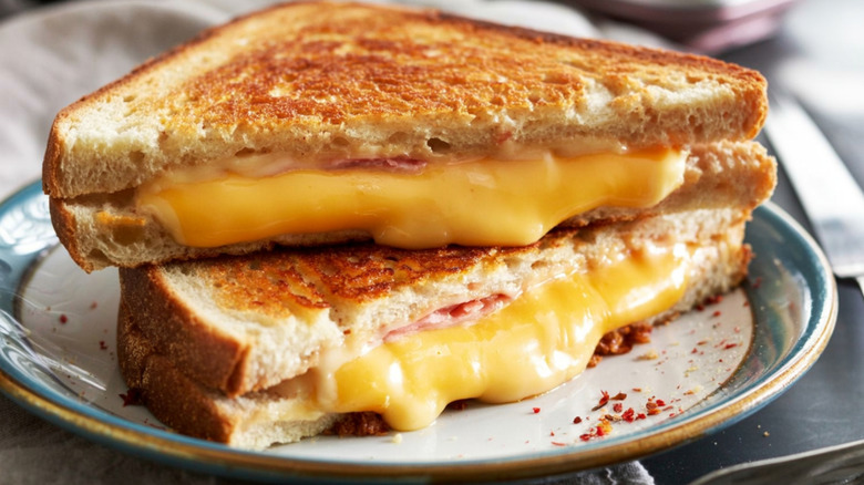 stacked, gooey grilled cheese on plate