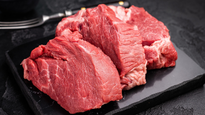 Raw beef on a black board