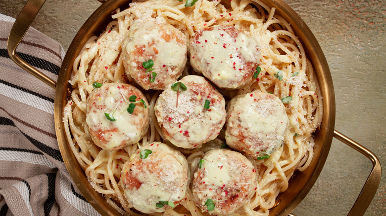 pasta with meatballs and spaghetti in a white sauce