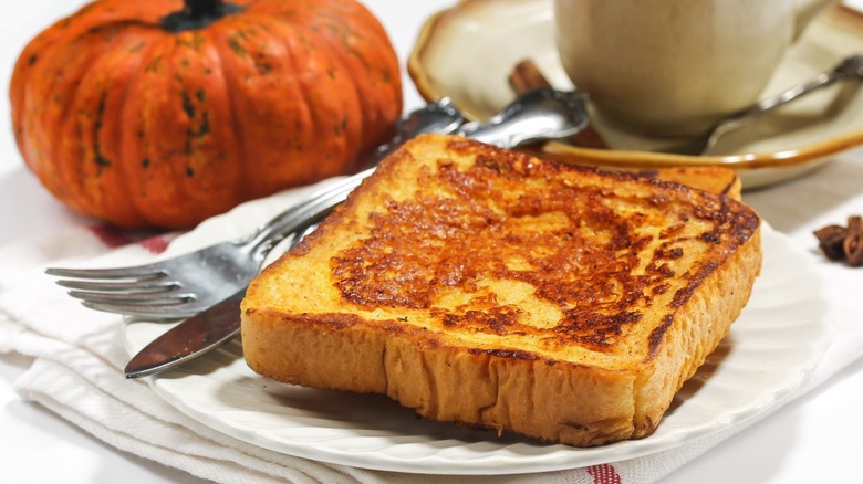french toast on dish alongside rustic pumpkin